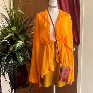 Orange summer neon blouse with Hawaiian artistry purse.